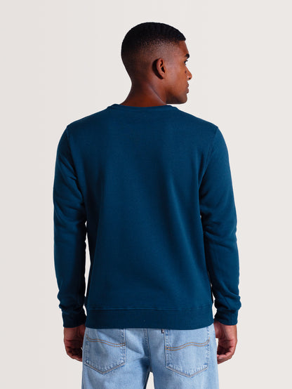 Parte de trás do moletom careca azul em tom escuro, sem estampas, com acabamento liso, punhos e barra ajustados. Ideal para estilo casual e confortável.